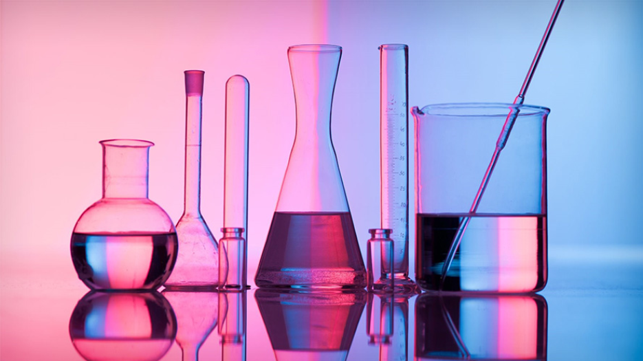 Laboratory glassware filled with clear liquid. The entire image is coloured blue on one half and pink on the other.